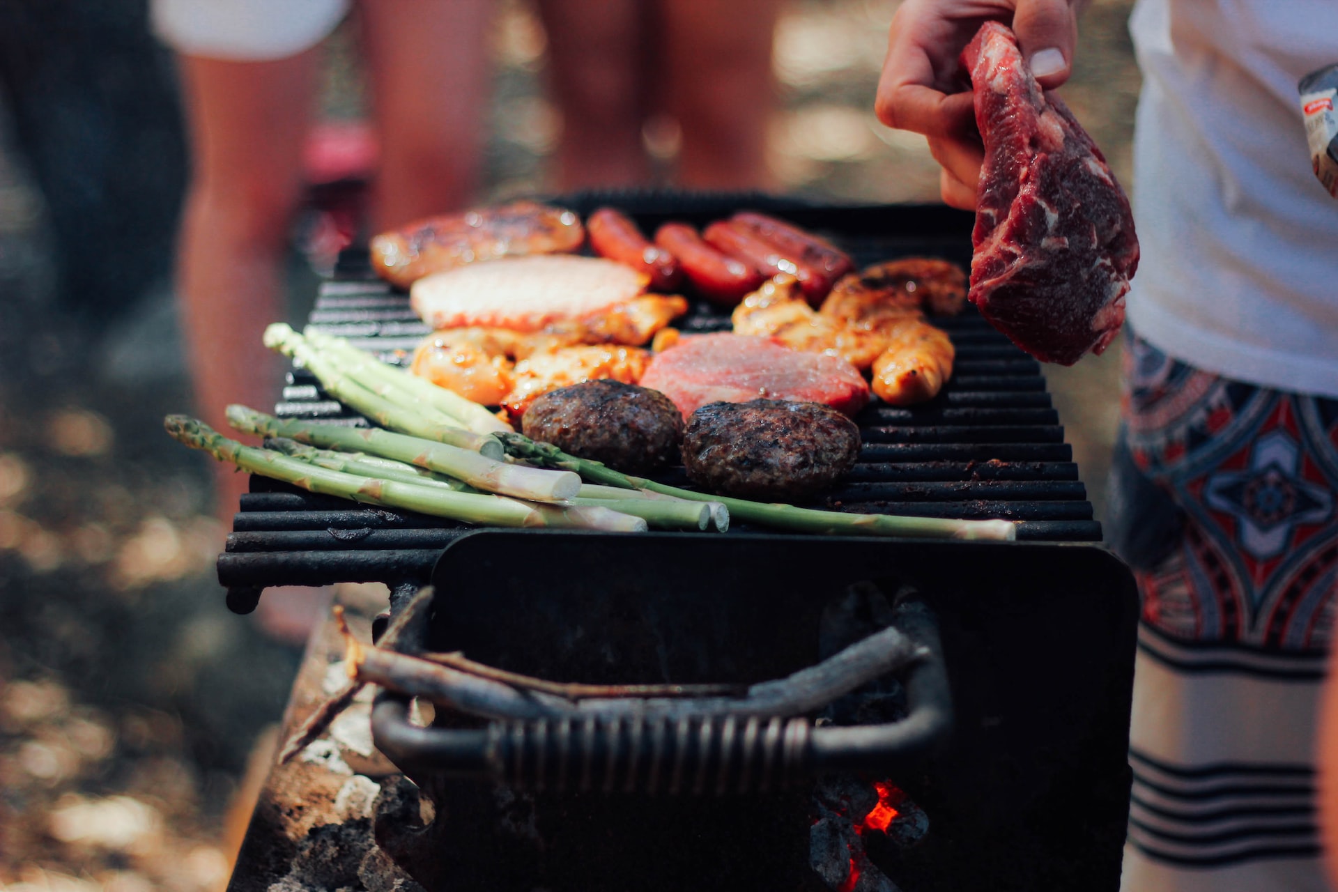stephanie-mccabe-ZWhVZ6-nw5I-unsplash Man cooking on grill.